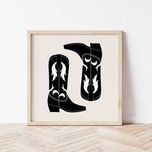 May include: A black and white illustration of two cowboy boots with white floral designs. The boots are on a beige background.