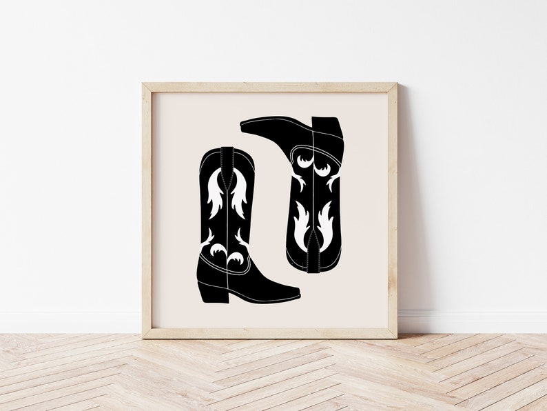 May include: A black and white illustration of two cowboy boots with white floral designs. The boots are on a beige background.