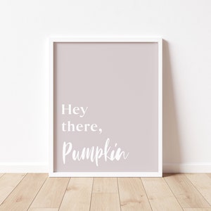 May include: A white framed print with a light pink background and the text "Hey there, Pumpkin" in white.