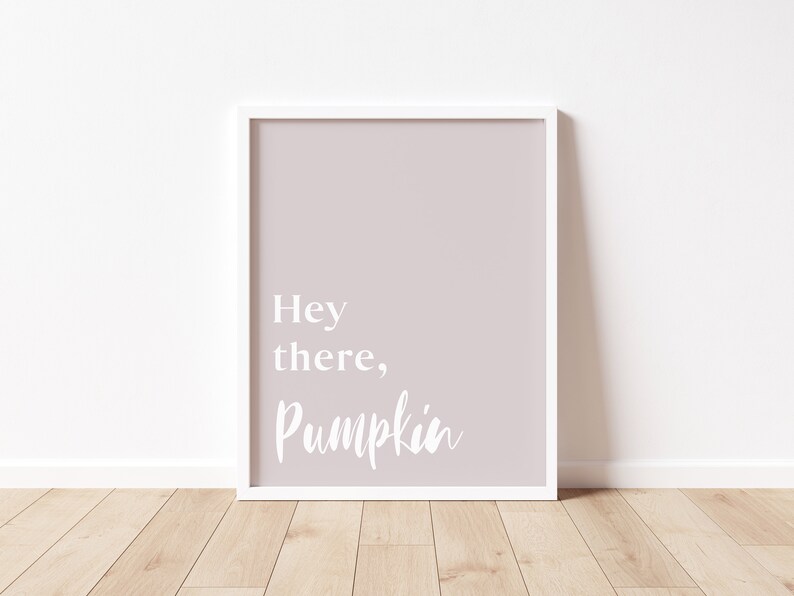 May include: A white framed print with a light pink background and the text "Hey there, Pumpkin" in white.