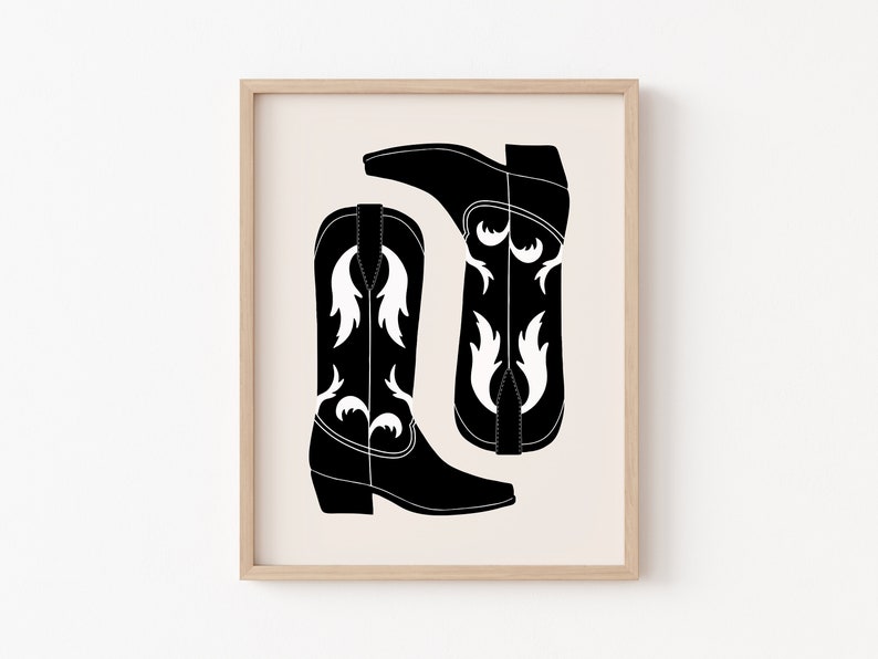 May include: A printable art print featuring a black and white illustration of two cowboy boots with a floral design.