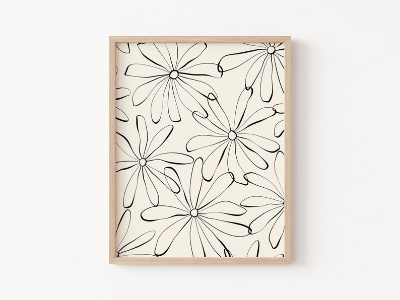 Puede incluir: Una impresi&oacute;n enmarcada con un dise&ntilde;o minimalista que presenta dibujos de l&iacute;neas negras de flores estilizadas sobre un fondo crema.