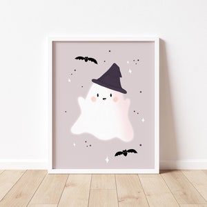 May include: A white ghost wearing a black witch hat with a pink background and black bats. The ghost has a happy face with rosy cheeks.