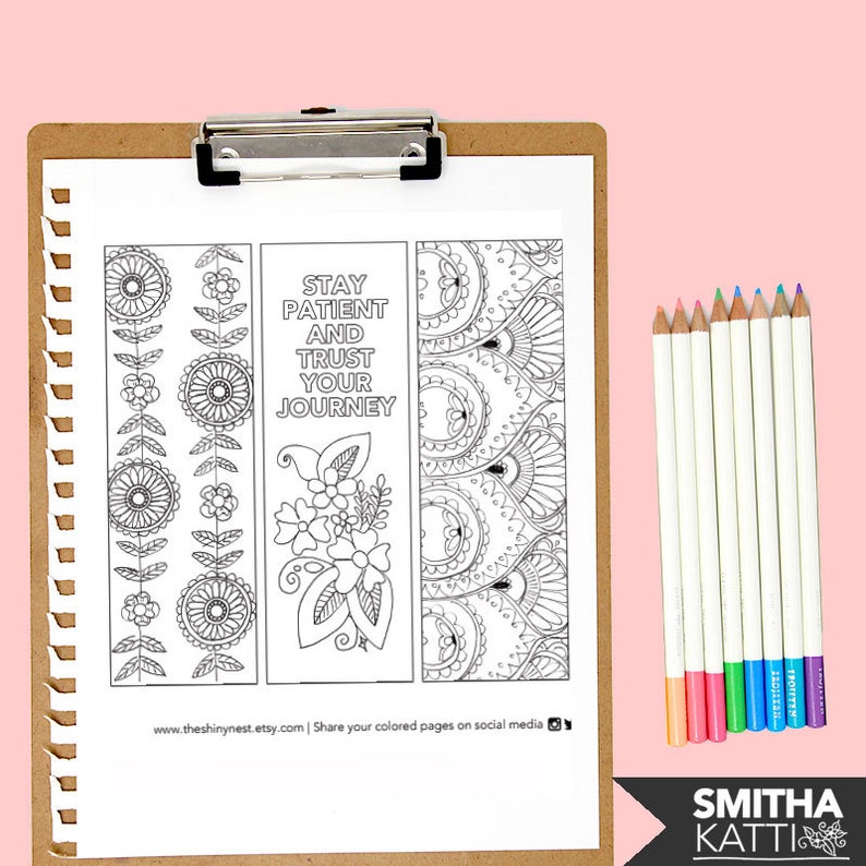 May include: A printable sheet with three bookmark designs featuring intricate patterns and the quote "Stay patient and trust your journey". The sheet is on a clipboard with coloured pencils.