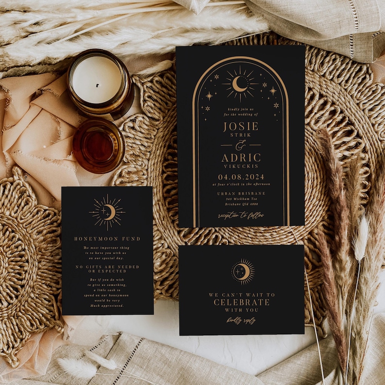 eclipse celestial wedding invitation suite with sun and moon design on a dark background
