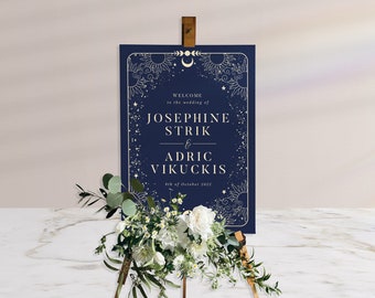 May include: A navy blue wedding welcome sign with gold lettering and celestial illustrations. The sign reads "Welcome to the wedding of Josephine Strik & Adric Vikuckis 8th of October 2022".