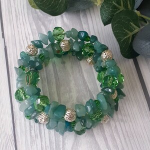May include: A green and silver beaded bracelet with a variety of green stones and silver beads. The bracelet is made of natural stones and is a beautiful and unique piece of jewelry.