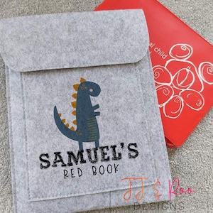 May include: A gray felt book cover with a dinosaur design and the text "SAMUEL'S RED BOOK".
