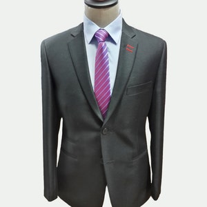 May include: A black suit jacket with a single button closure. The jacket has a pink and purple striped tie.