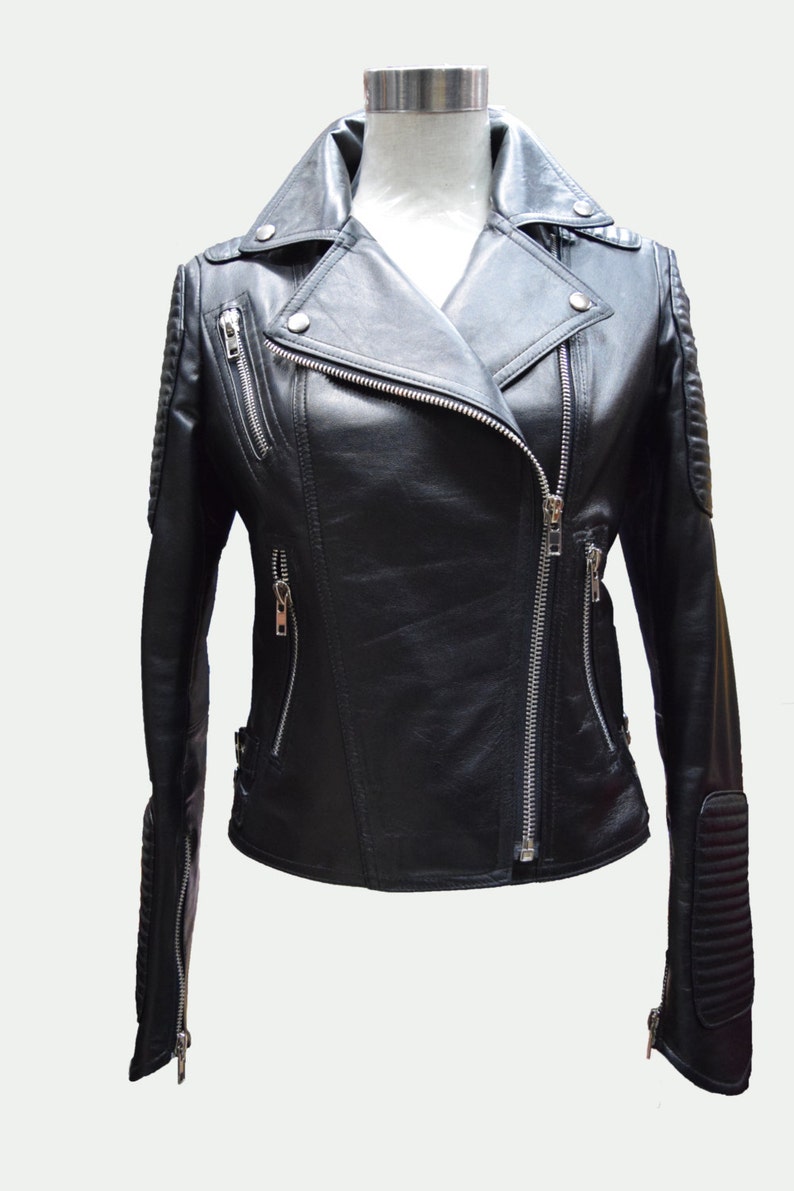 May include: A black leather motorcycle jacket with a zipper closure and silver hardware. The jacket has a stand-up collar and zippered pockets.