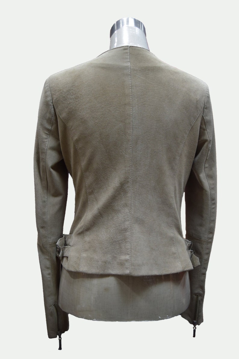 May include: A light brown suede jacket with a zipper closure and a belt at the waist.