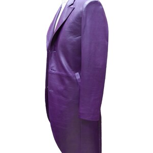 May include: A purple long-sleeved jacket with a tailcoat style. The jacket has a single-breasted closure with buttons and a pointed collar.