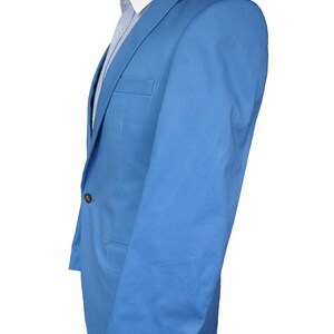 May include: A light blue blazer with a single button closure and two pockets. The blazer has a plain design and is made of a smooth fabric.