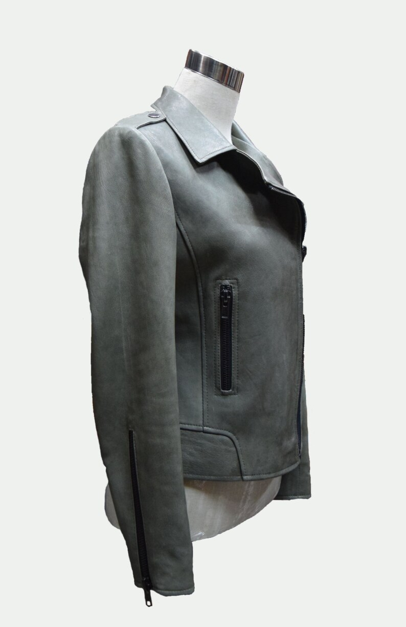 May include: A green leather motorcycle jacket with a zippered pocket on the left side and a zippered closure at the bottom of the sleeves.