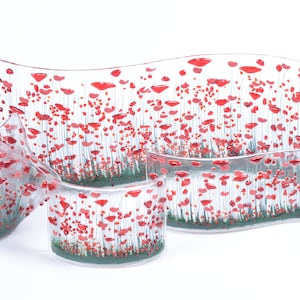 May include: Set of four glass bowls featuring a poppy flower design. The bowls are clear glass with red poppy flowers and green stems. The bowls are of varying sizes and shapes.