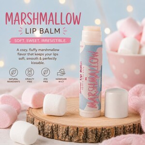 May include: A cylindrical tube of marshmallow lip balm with a light blue and pink patterned label. The label features the text MARSHMALLOW LIP BALM, NET WT 0.15 OZ / 4.25 G, and icons for natural ingredients, cruelty-free, dye-free, and handmade in CT.