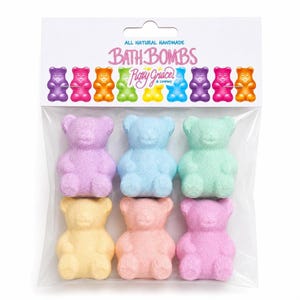A clear plastic bag holds six colorful bear-shaped bath bombs in purple, blue, green, yellow, peach, and pink.