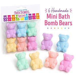 A clear bag of six colorful bear bath bombs sits next to four loose bear bath bombs on a white surface.