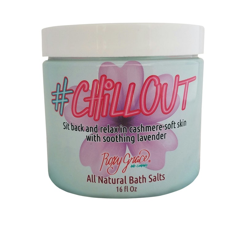 May include: A white jar with a blue and pink label. The label says "#CHILLOUT" in pink and white letters. The label also says "Sit back and relax in cashmere-soft skin with soothing lavender" and "Rory Grace All Natural Bath Salts 16 fl Oz".