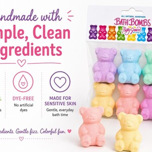 A clear package of six bear bath bombs is displayed beside text detailing clean ingredients and a rolled white towel.
