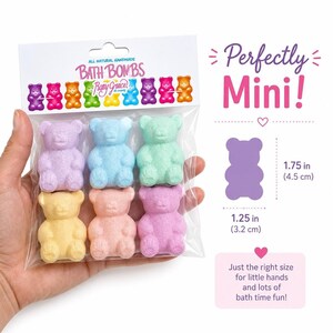 A hand holds a package of six bear bath bombs with text displaying product dimensions on the right.