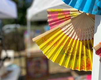 Colorful wooden fan pimped with colored stencil