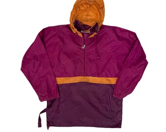 May include: A hooded anorak jacket in shades of purple, orange, and gold. The jacket features a half-zip closure, a kangaroo pocket, and a drawstring hood. The lower portion of the jacket is a darker shade of purple.