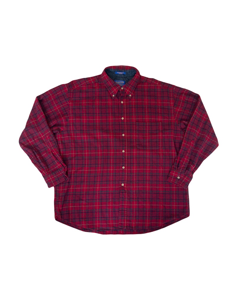 May include: A red and black checked long-sleeved button-down shirt.