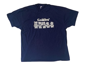 May include: A navy blue t-shirt with a white graphic of five cartoon bears wearing jerseys with the text "Goldies' Bears" printed on the front.