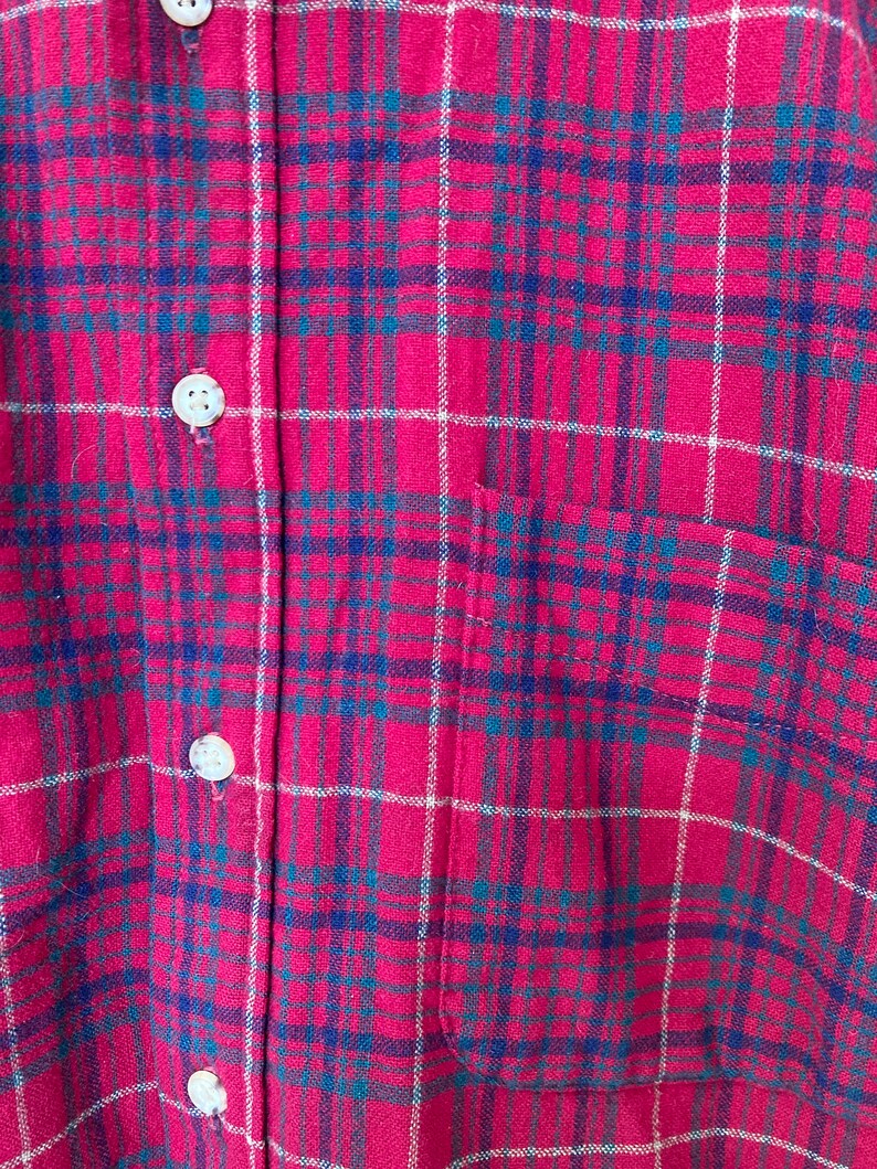 May include: Red and blue plaid flannel shirt with a single chest pocket.