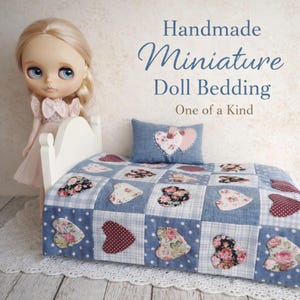 May include: Handmade miniature doll bedding set. The set includes a blue and white checkered quilt with heart-shaped appliqués in floral and polka dot patterns, a matching pillow, and a white bed frame. The text reads "Handmade Miniature Doll Bedding One of a Kind."