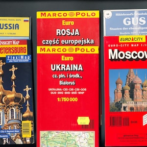 May include: A collection of four travel maps featuring Russia, St. Petersburg, Moscow, and Ukraine. The maps are in various languages, including English, Russian, Polish, and Ukrainian. The maps are all in a red, white, and blue color scheme.