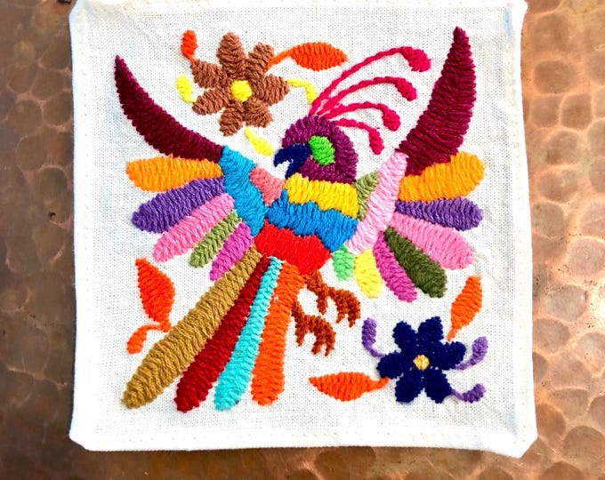 Otomi hand embroidered muslin coaster with multicolored bird and flowers.