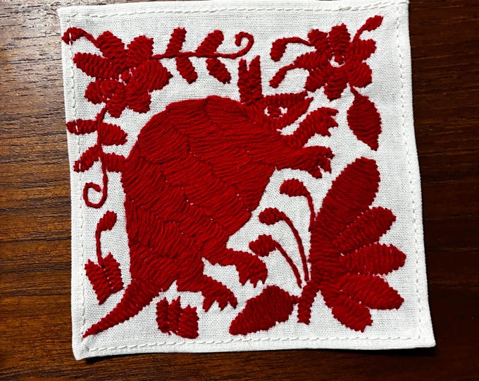 Otomi hand embroidered muslin cotton coaster / cocktail napkin / frame-able art with red animal and flowers. (4 1/4” x 4 1/4”)
