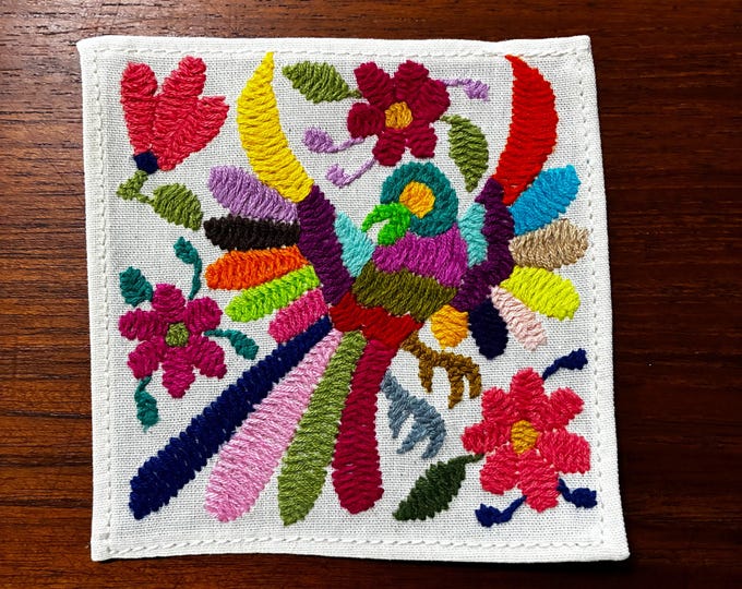 Otomi hand embroidered muslin cotton coaster / cocktail napkin / frame-able art with multicolored bird and flowers. (4 1/4” x 4 1/4”)
