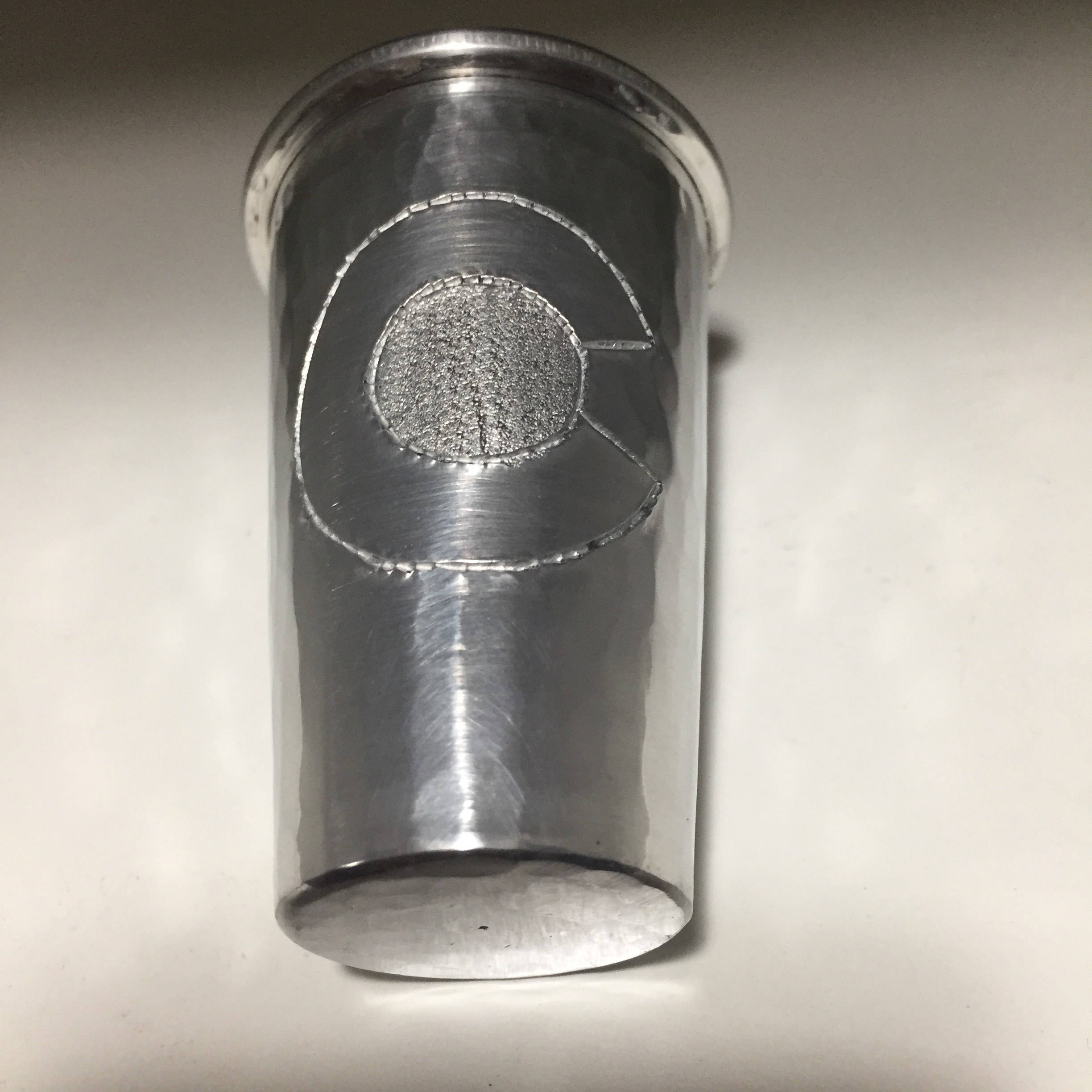 Handcrafted 2oz hammered aluminum shot glass with Colorado C engraved