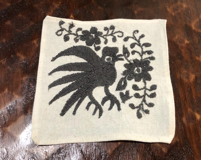 Otomi hand embroidered muslin coaster / cocktail napkin / frame-able art with dark grey bird and flowers.