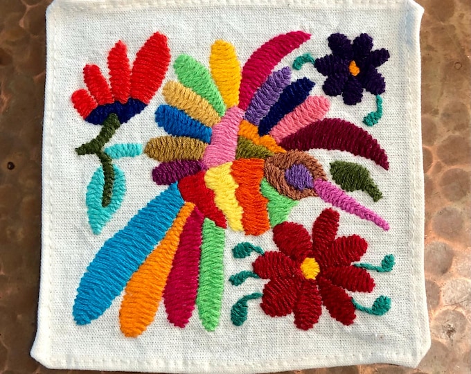 Otomi hand embroidered muslin coaster with multicolored bird and flowers.