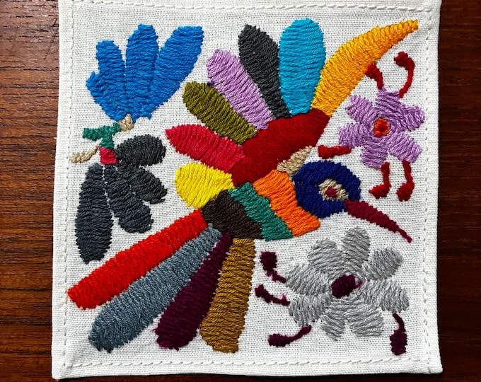 Otomi hand embroidered muslin cotton coaster / cocktail napkin / frame-able art with multicolored bird and flowers. (4 1/4” x 4 1/4”)