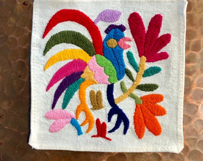 Otomi hand embroidered muslin coaster with multicolored bird and flowers.