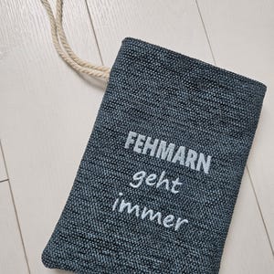 May include: A white ceramic mug with a black handle and the text "But First, Coffee" in a handwritten style. The mug is on a white surface. The mug is approximately 4 inches tall.