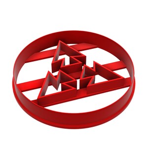 May include: A bright red cookie cutter in the shape of a Christmas tree, enclosed within a circular frame. The tree design is composed of several triangular shapes, creating a festive holiday theme against a black background.