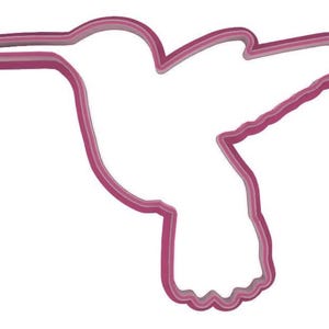 Puede incluir: Un cortador de galletas en forma de colibr&iacute; rosa. El cortador est&aacute; hecho de un material s&oacute;lido y liso y presenta un contorno detallado de un colibr&iacute; en vuelo. El dise&ntilde;o incluye las alas, el pico y la cola del ave.