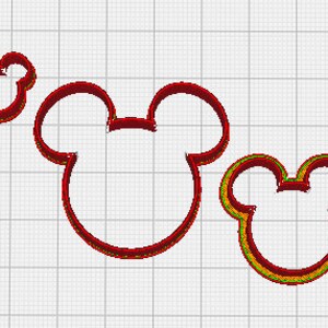 May include: Three red cookie cutters in the shape of a mouse head with large round ears. The cutters are different sizes, with the largest one in the center and the smallest one at the top left. The cutters have a thin, detailed design.
