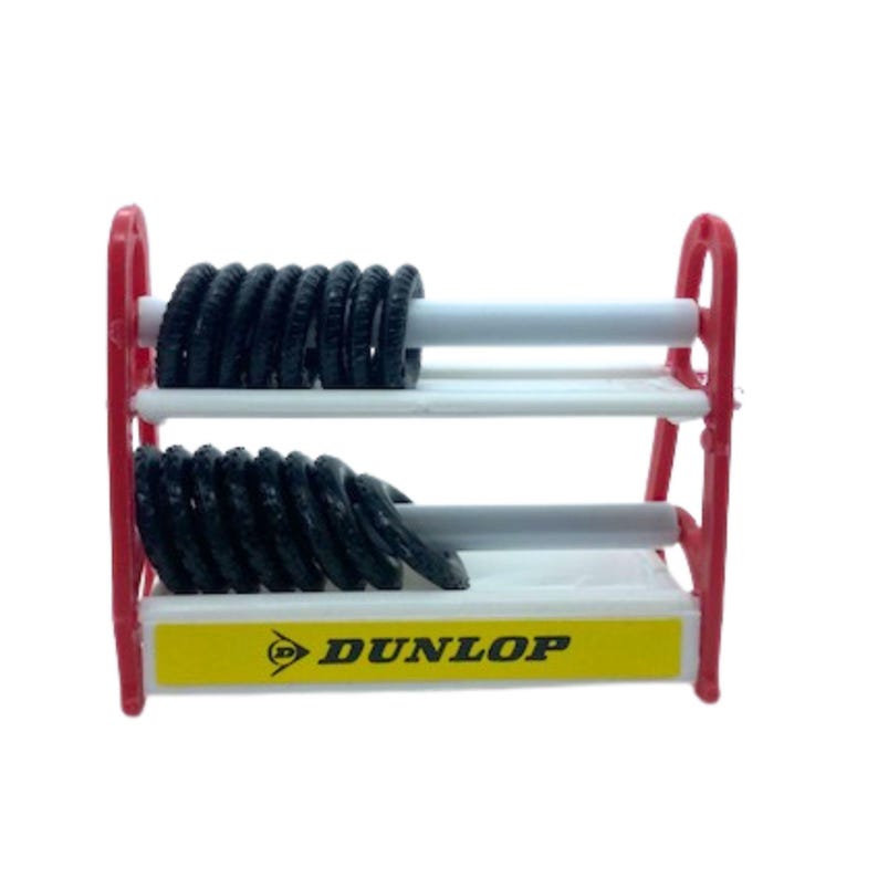 Puede incluir: Un expositor de neum&aacute;ticos en miniatura con neum&aacute;ticos negros y el logotipo de Dunlop. El expositor tiene un marco rojo, estantes blancos y una base amarilla. Los neum&aacute;ticos est&aacute;n dispuestos en filas en los estantes.