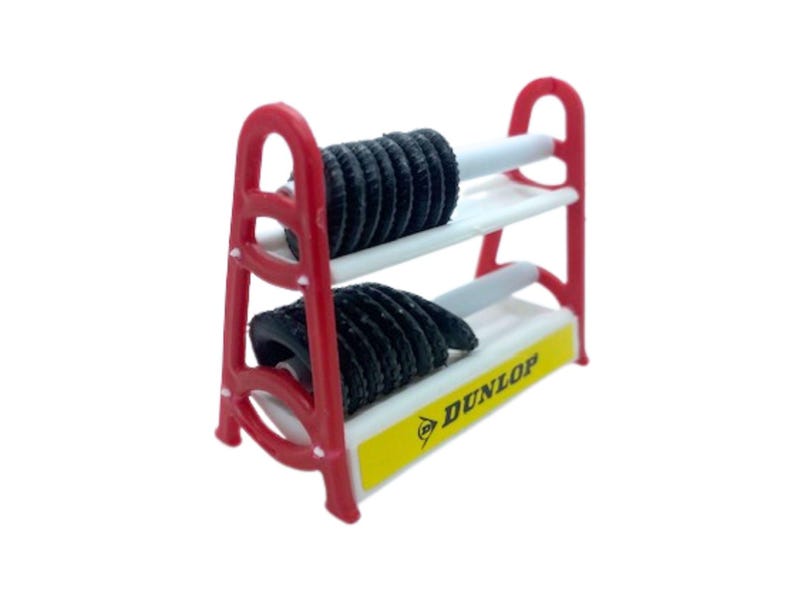Puede incluir: Un peque&ntilde;o estante rojo y blanco que sostiene dos neum&aacute;ticos negros. El estante tiene un letrero amarillo con la palabra "DUNLOP" impresa. Los neum&aacute;ticos son negros y tienen un dibujo acanalado.
