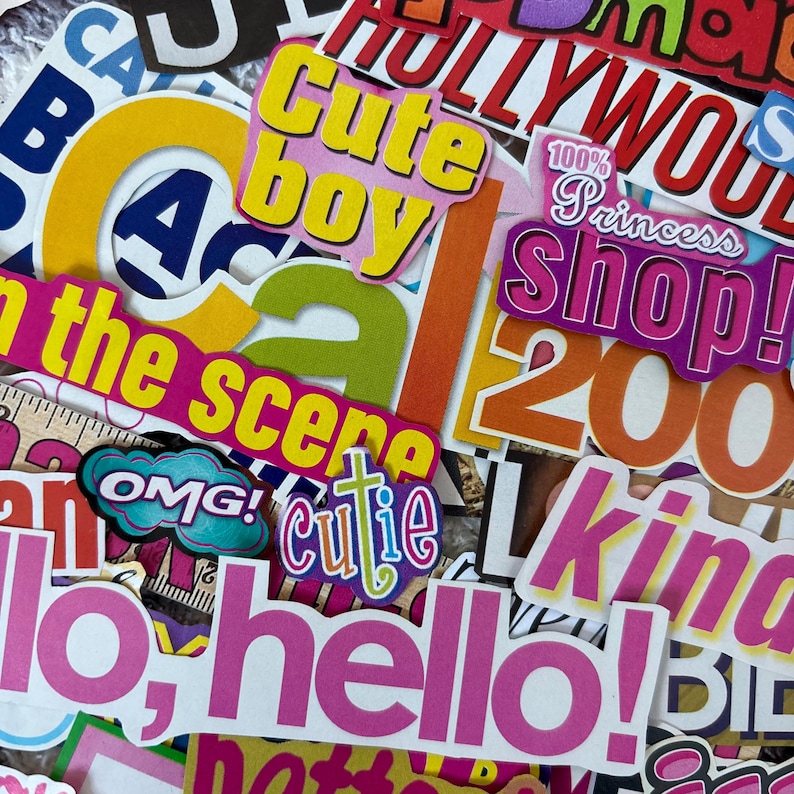 May include: A collection of colorful stickers with various text and designs. The stickers include phrases like "Cute boy," "Hello," and "Hollywood." The color palette includes pink, yellow, orange, and blue.