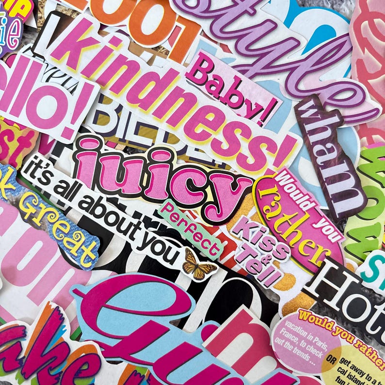 May include: A collection of colorful stickers with various phrases and words, including "Juicy," "Kindness," and "Baby!" The stickers feature a mix of fonts and colors, such as pink, orange, and blue, creating a vibrant and eye-catching design.