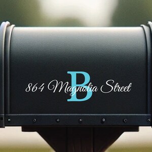 May include: Black mailbox with a white address sticker that reads "864 Magnolia Street" and a blue letter "B" sticker.