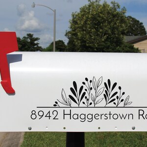 Rustic mailbox with custom floral design decal, demonstrating how to enhance curb appeal